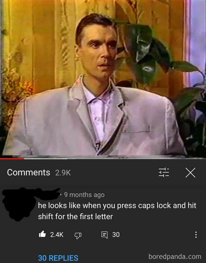 A comment section post describing a man in an oversized suit looks like he pressed caps lock and hit shift for the first letter, showcasing funny comments.