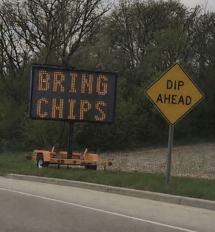 Two chaotic signs in the wild: an electronic road sign says BRING CHIPS, next to a yellow diamond DIPP AHEAD sign.