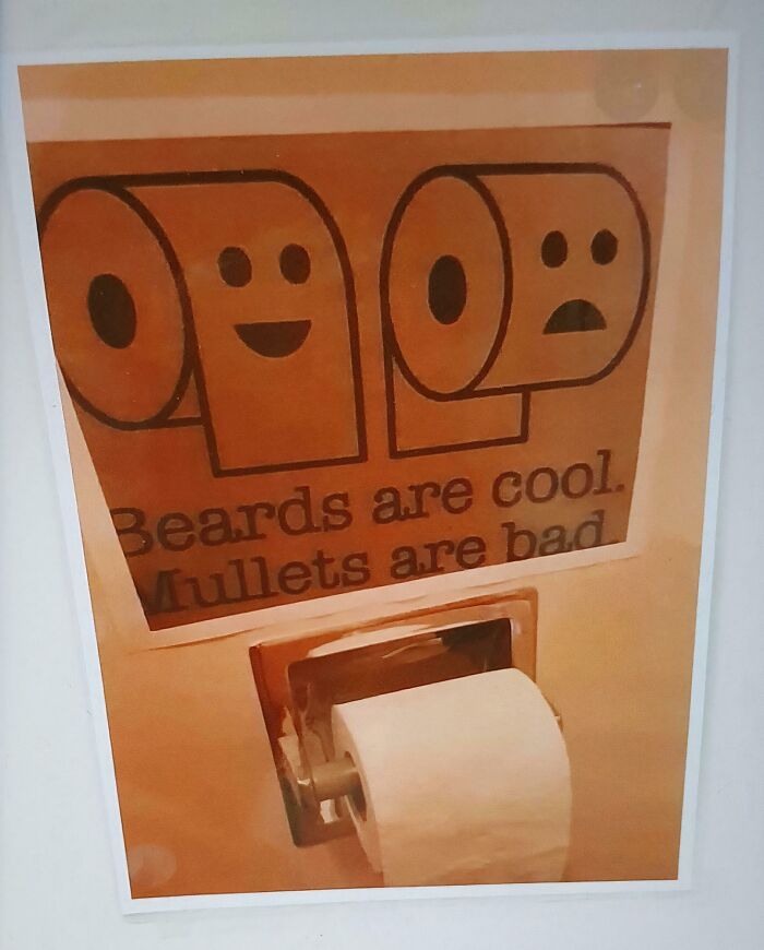 A funny chaotic sign spotted in the wild with toilet paper rolls depicting beards as cool and mullets as bad.