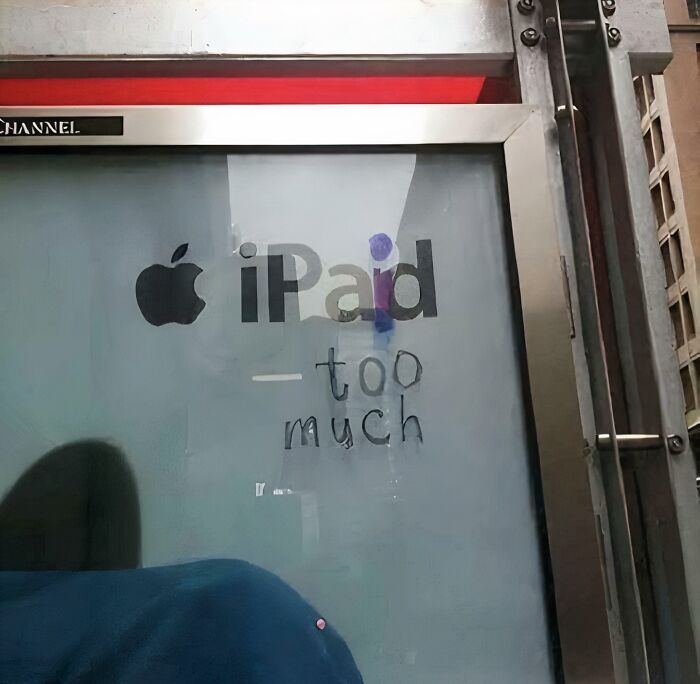 Chaotic sign: An Apple iPad ad with graffiti saying -too much, a funny sight spotted in the wild.