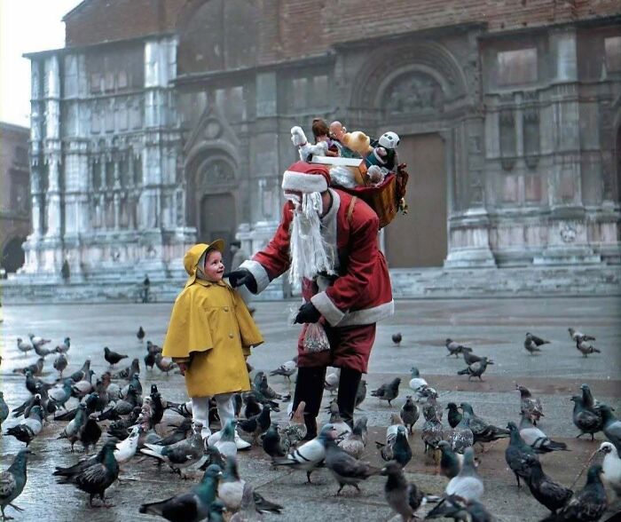 A heartwarming historical colorized photo shows Santa Claus with a child among pigeons, making the past feel vibrant.