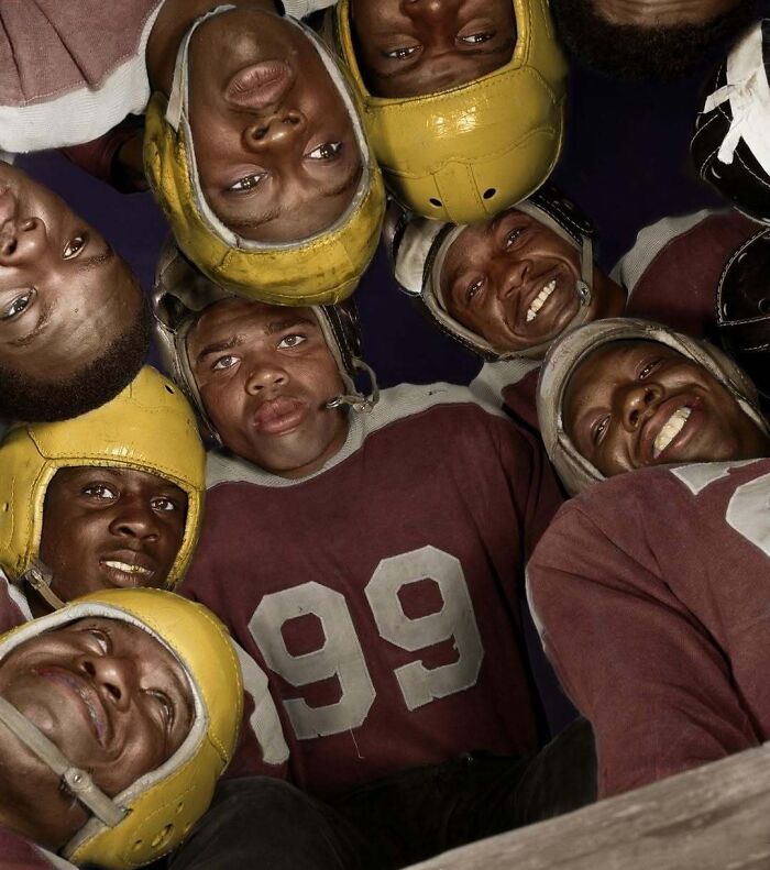 Historical colorized photos: A group of smiling football players in vintage uniforms and yellow helmets looking down at the camera.