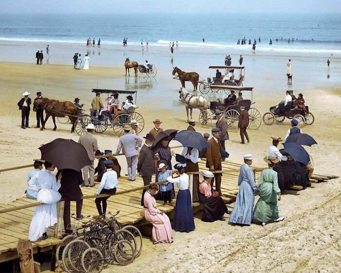 Historical colorized photos: A busy beach scene with people and horse-drawn carriages on the sand and boardwalk.