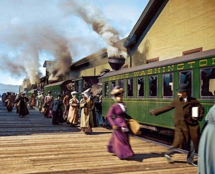 A historical colorized photo of passengers boarding a train, making the past come to life.