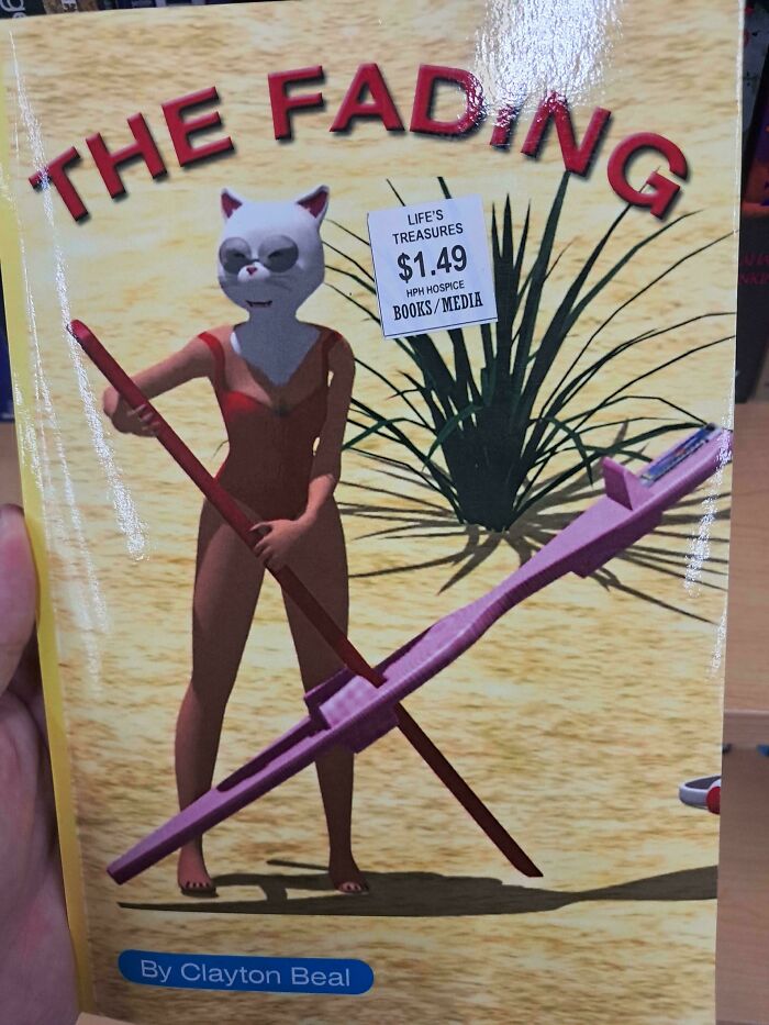 An unhinged book cover titled The Fading featuring a low-budget CGI cat person in a red swimsuit on a beach