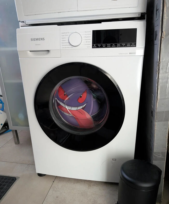 Hilarious photo of a Gengar Pokemon plush toy in a washing machine, showcasing funny internet content.