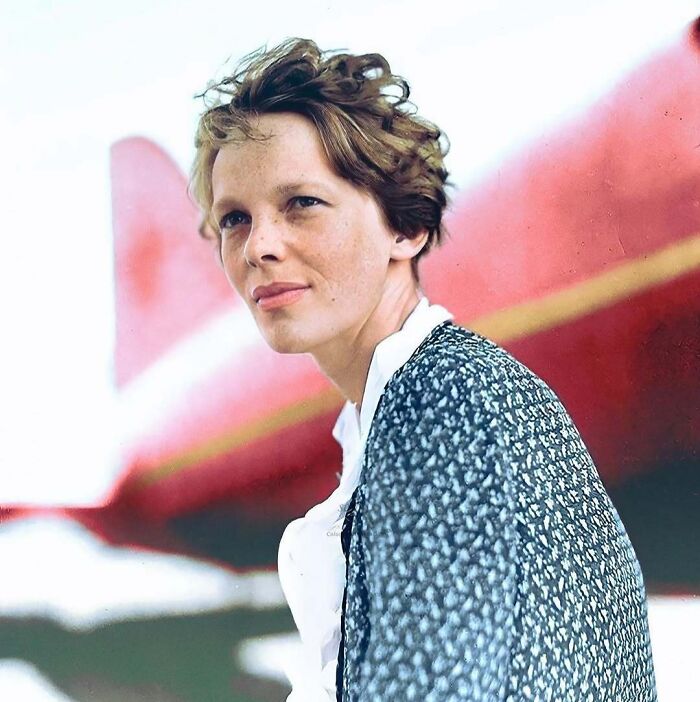 Historical colorized photos: Amelia Earhart with short, curly hair and a patterned jacket, standing next to a red plane.