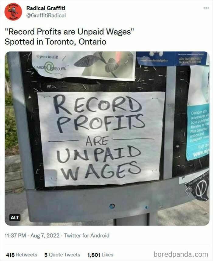 A sign on a bulletin board reads Record Profits are Unpaid Wages, highlighting disturbing levels of USA dystopia.