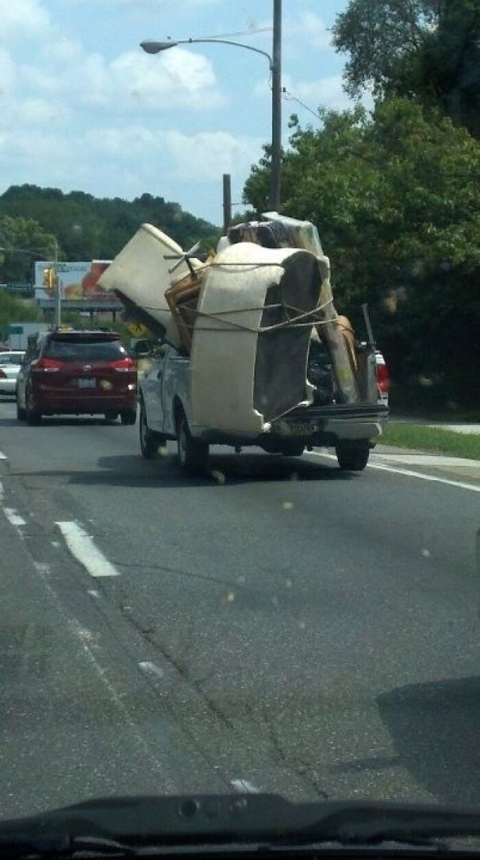 Pickup truck carrying bulky furniture unsecured on highway in moving fails pics
