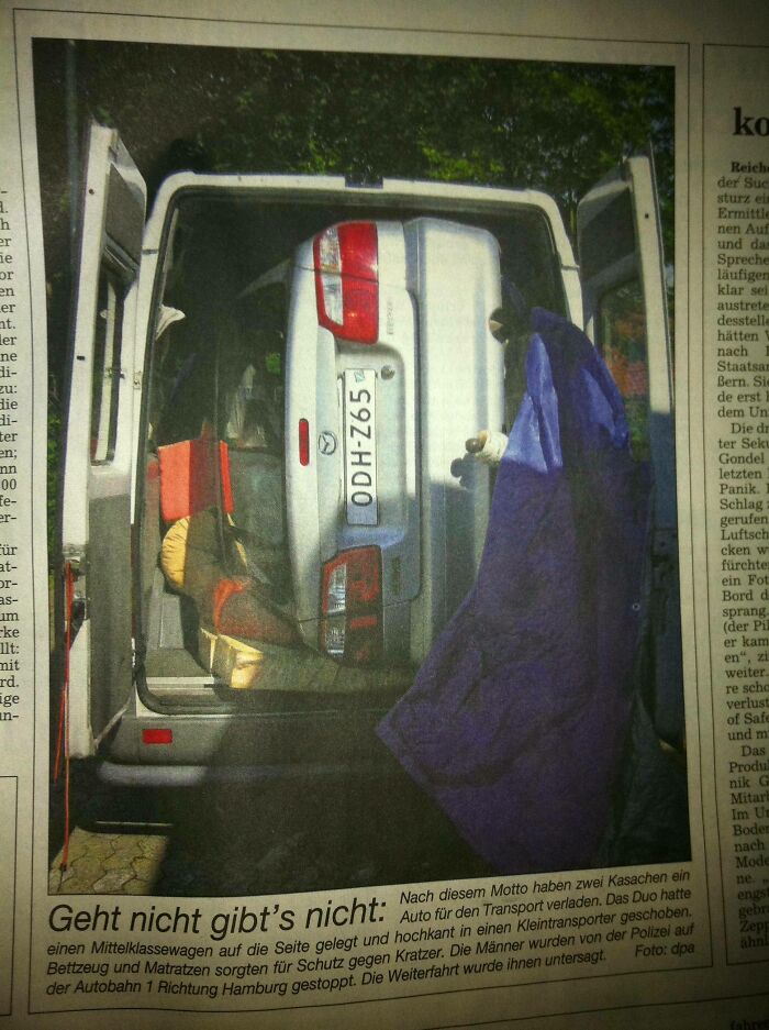 Small car awkwardly packed inside a van for a moving fail scene captured in newspaper