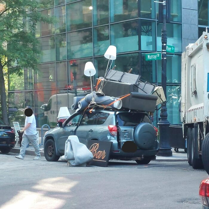 Car overloaded with furniture and lamps tied to roof during moving fails