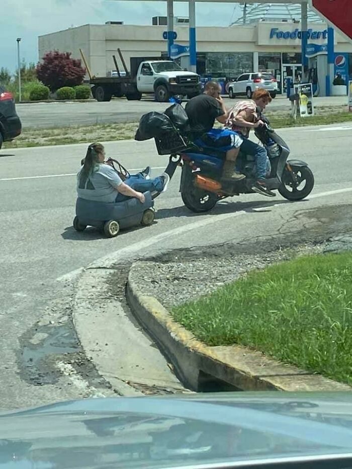 Moving fails with person being pulled in a small cart behind scooter