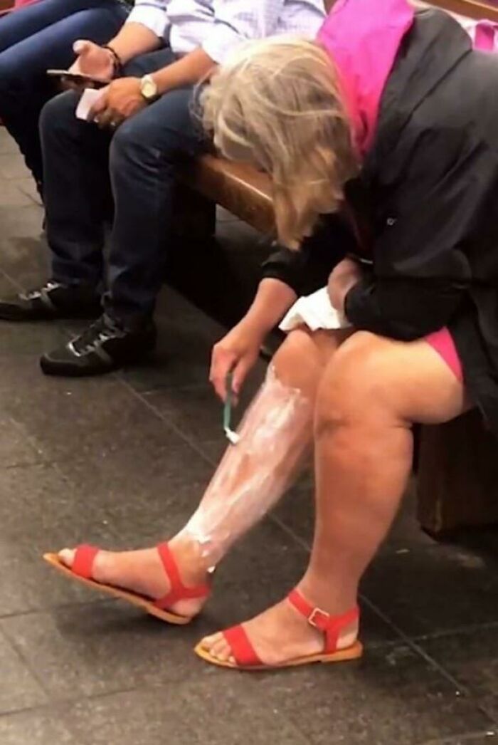 Bizarre public transport interactions showing a woman shaving her legs on a subway train bench