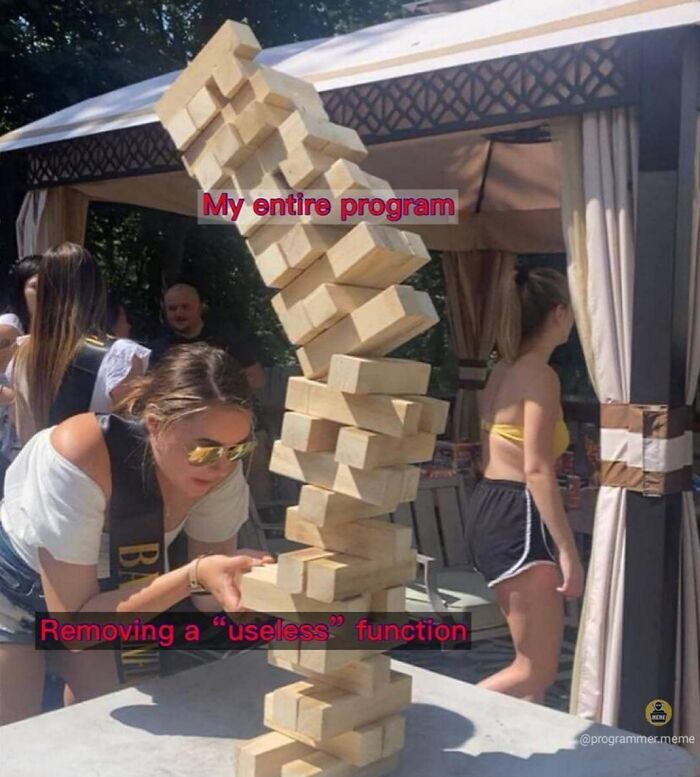 Jenga blocks wobbling labeled as program and removing a useless function meme