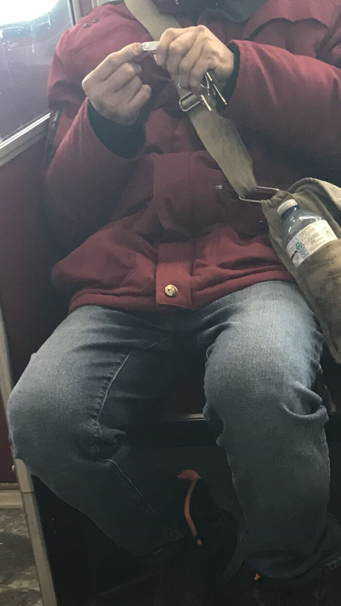 Man uses nail clippers on a subway, showing unpleasant public transport interactions.