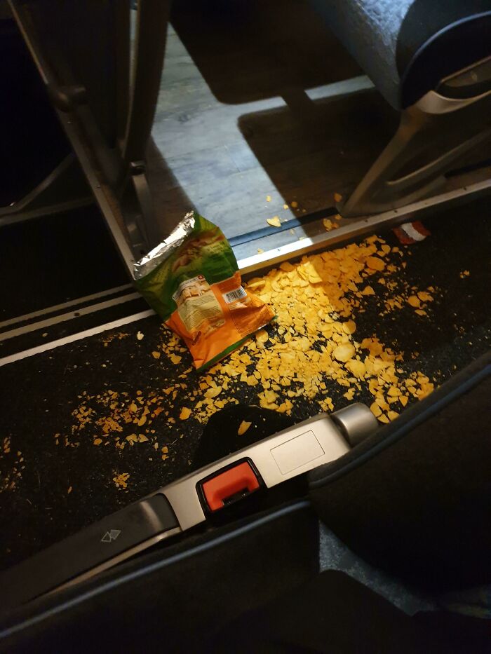 Spilled potato chips mess on a train floor, showing bad public transport interactions.