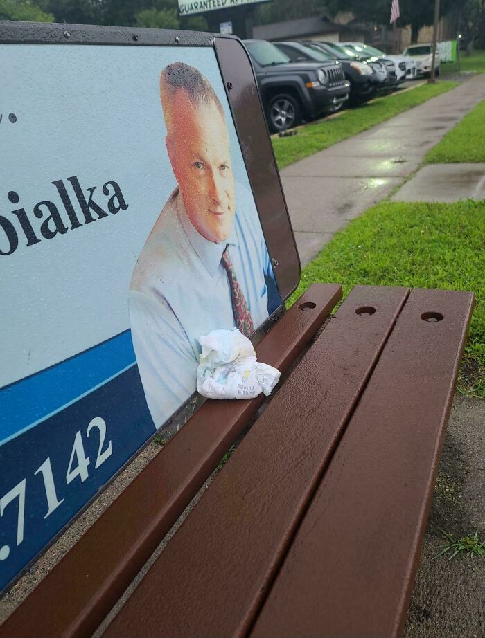 Dirty diaper left on a bus stop bench, depicting gross public transport interactions.