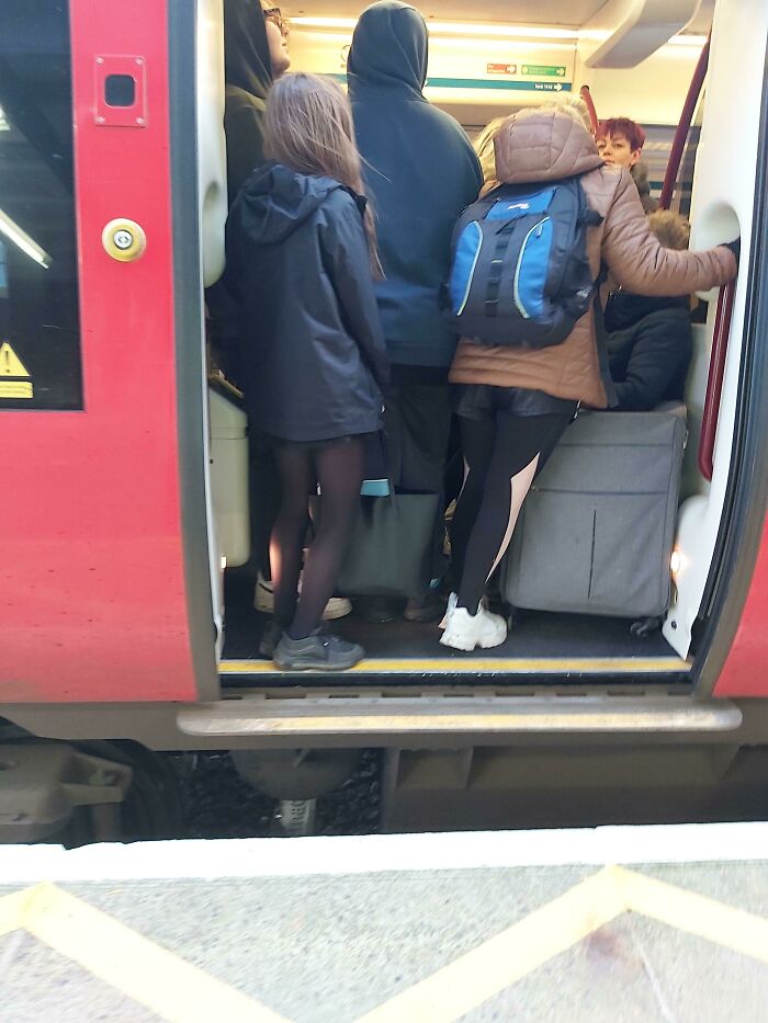 Passengers standing by the doors on crowded public transport