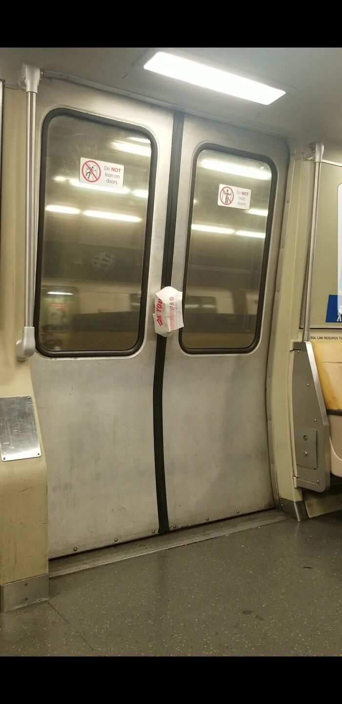 Takeaway bag caught in the closed doors of a public transport train