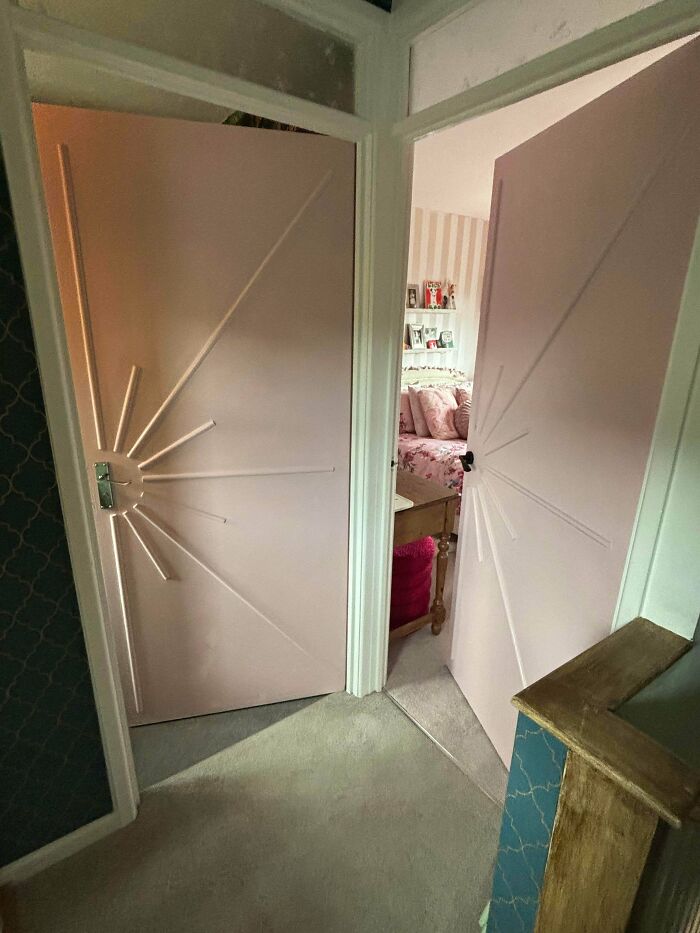 Two doors painted pink with an elegant starburst design, showing a creative DIY home upgrade