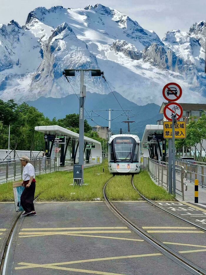 A modern tram line with a snow-capped mountain backdrop, showcasing some of the world’s best infrastructure.