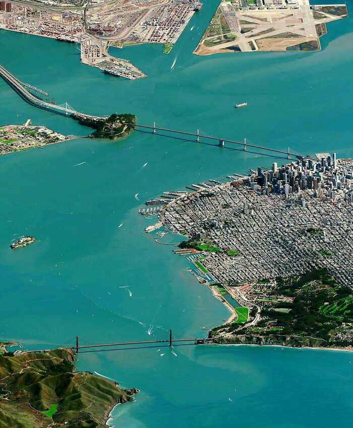 An aerial view of San Francisco and its iconic bridges, demonstrating coastal city infrastructure.