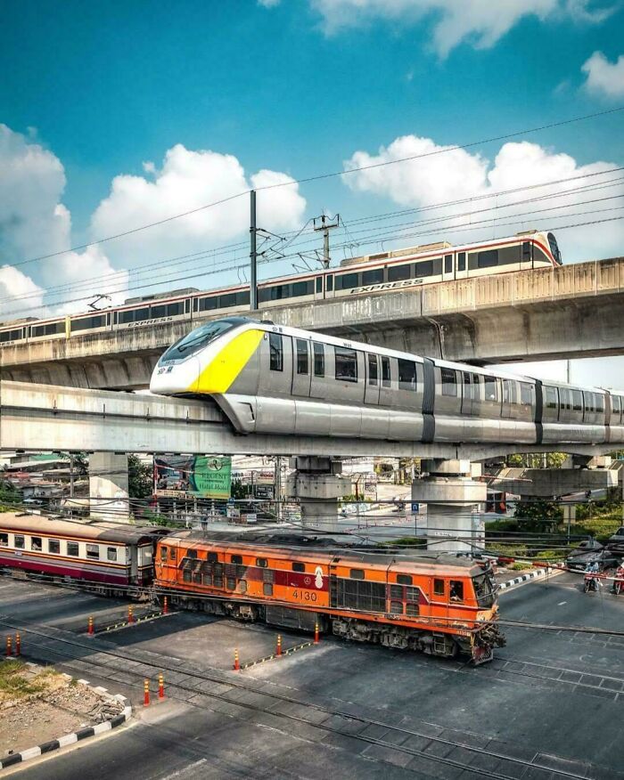 Three levels of trains and subways crossing each other, highlighting complex transportation infrastructure.