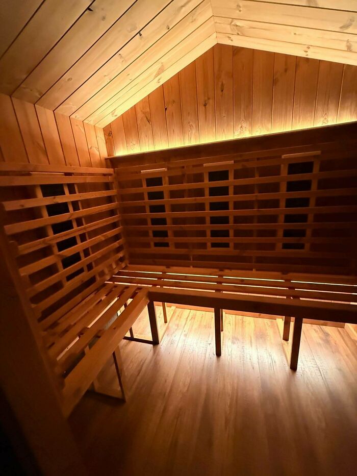 Interior of a cozy home sauna with wooden paneling, a DIY home upgrade that looks expensive.