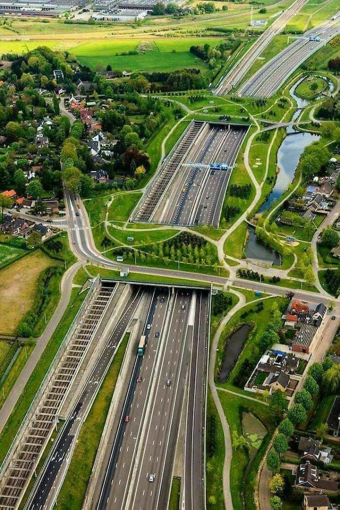 Aerial view of a green highway tunnel showcasing the world's best infrastructure