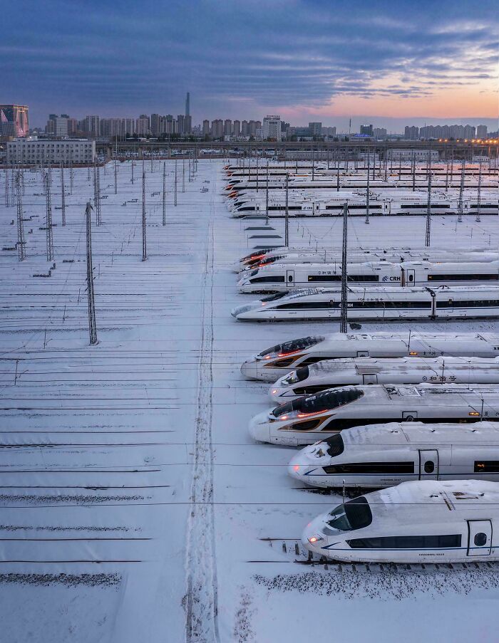 High-speed trains lined up in a snow-covered yard showing world’s best infrastructure