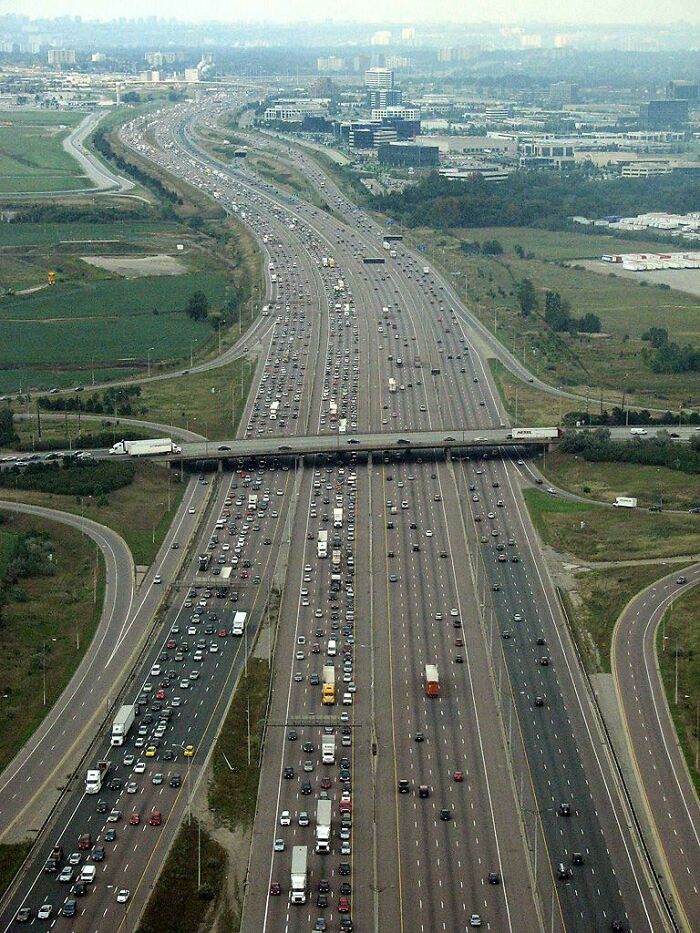 A massive multi-lane highway packed with traffic, showcasing some of the world's best infrastructure