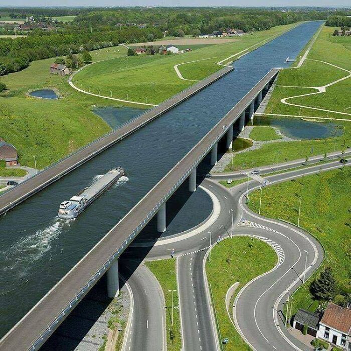 A unique water bridge allowing a boat to cross over a road, representing world's best infrastructure
