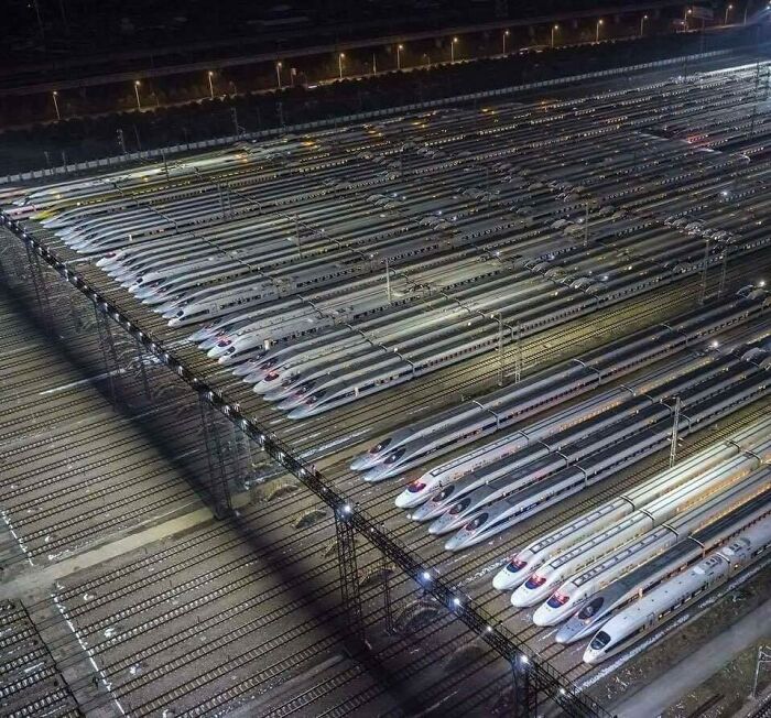 A massive depot filled with high-speed trains representing world's best infrastructure