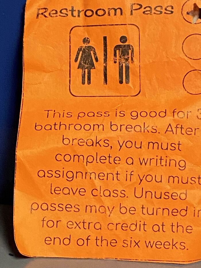 An orange school bathroom restroom pass with strict rules, showing how teachers manage their classrooms.