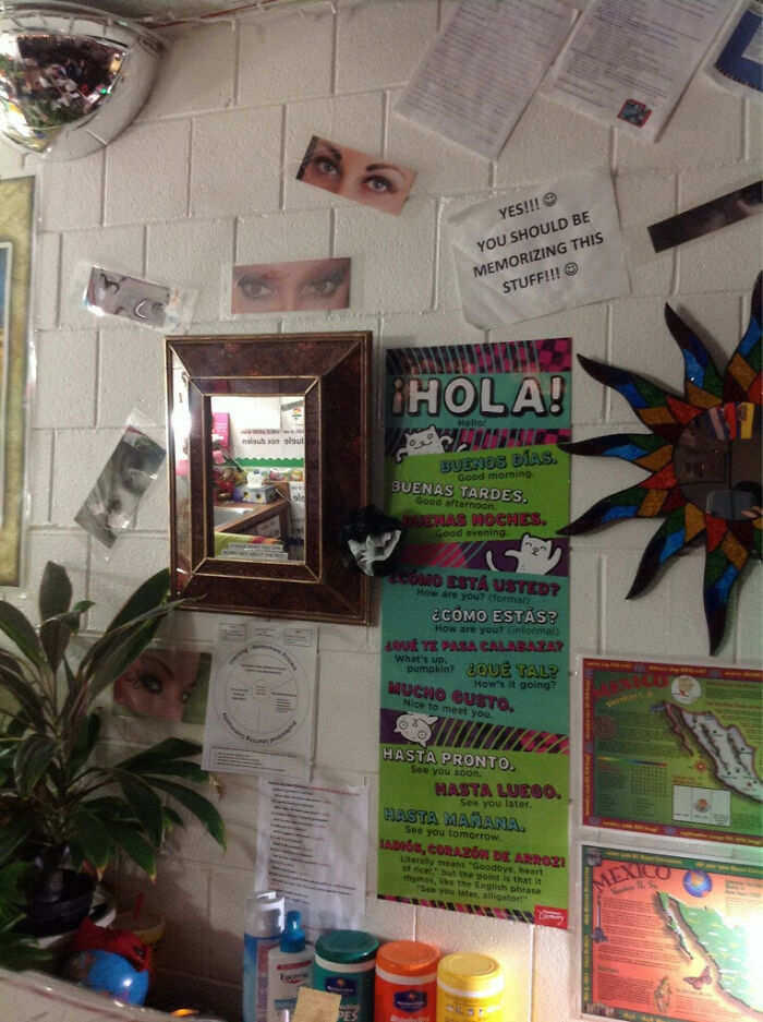Spanish classroom wall decorated by teachers showing Spanish greetings poster and cutout eyes