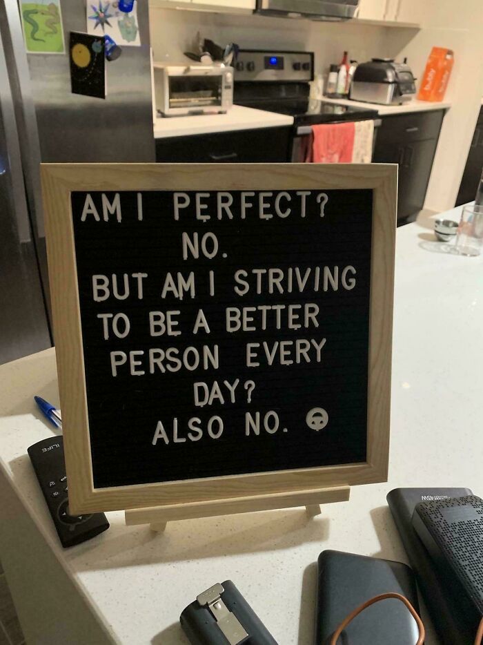 Humorous sign saying no to perfection and no to self-improvement