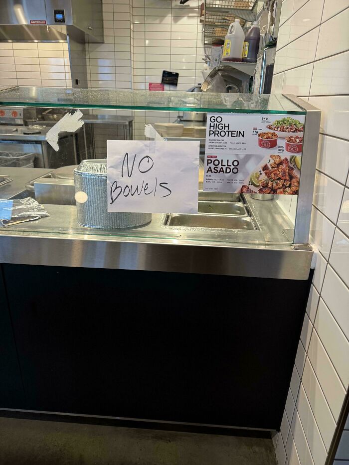 Handwritten sign saying no bowls at protein bowl counter