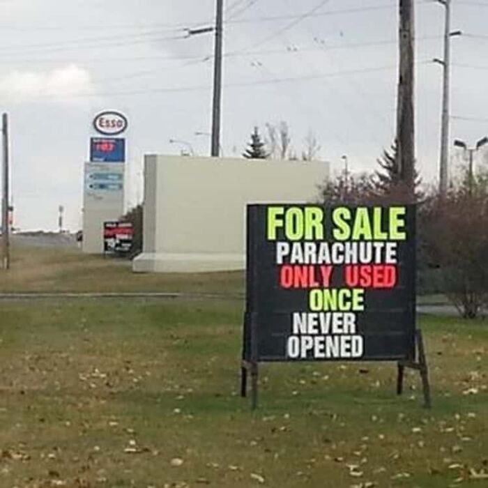 Unhinged sign selling parachute used once but never opened for sale