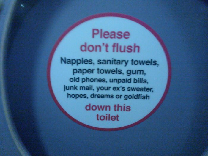 Funny toilet sign warning not to flush inappropriate items including hopes dreams or goldfish