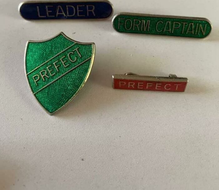A collection of vintage British school badges including Prefect and Form Captain, evoking British memes