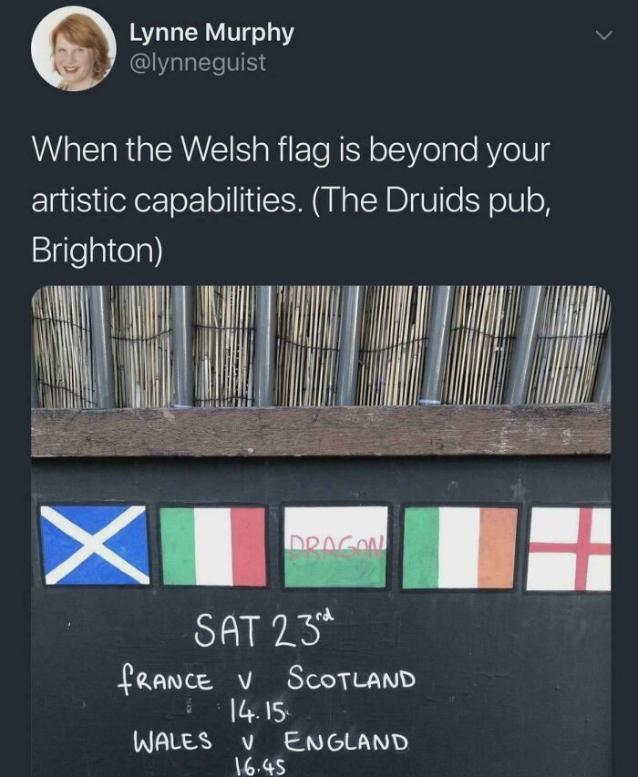 A pub chalkboard with flags and Dragon written for Wales, among relatable British memes