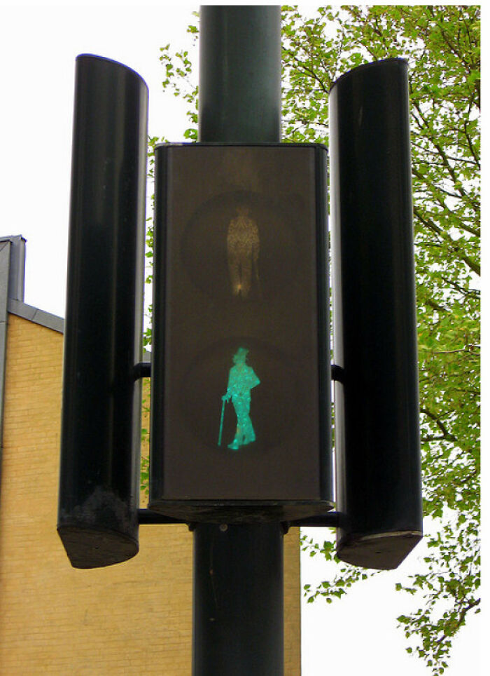 Unique pedestrian crossing light showing a green man with a cane and top hat