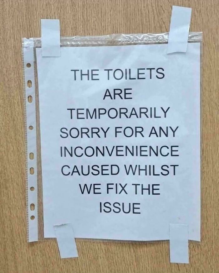 Humorous sign apologizing for temporarily closed toilets due to fixing issues