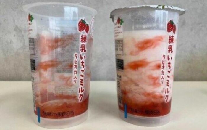 A clear plastic cup next to one printed with fake strawberry graphics as terrible product design