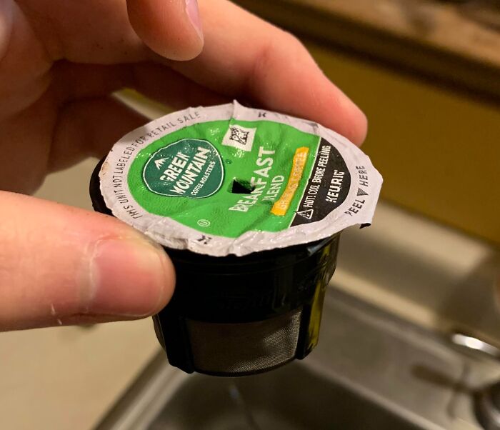 A coffee pod with a small filter basket, highlighting terrible product design