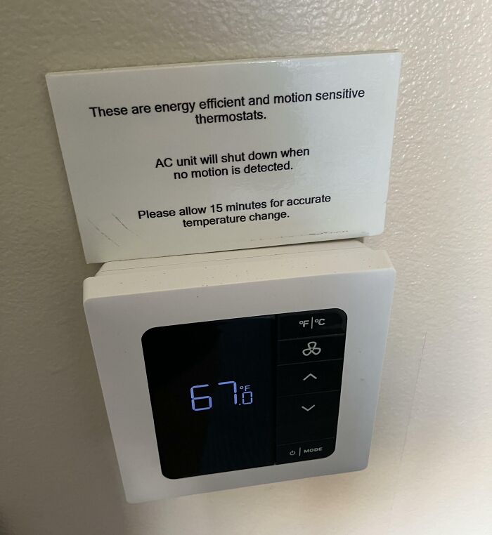 A motion-sensitive thermostat displaying 67 degrees with an irritating sign as an example of terrible product design