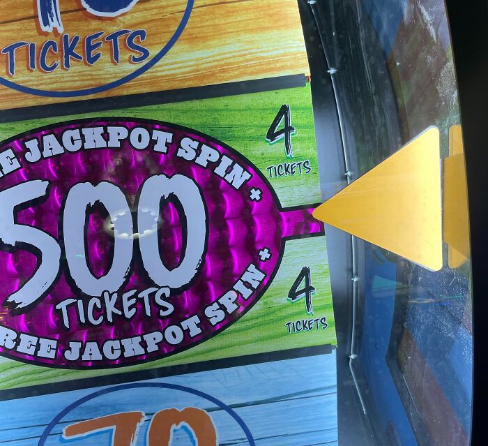 An arcade spin game showing a terrible product design where the pointer misses the win slot