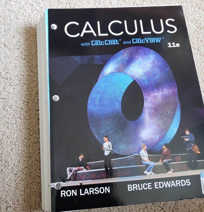 A calculus textbook with pre-punched binder holes that cut right through printed text, showing terrible product design