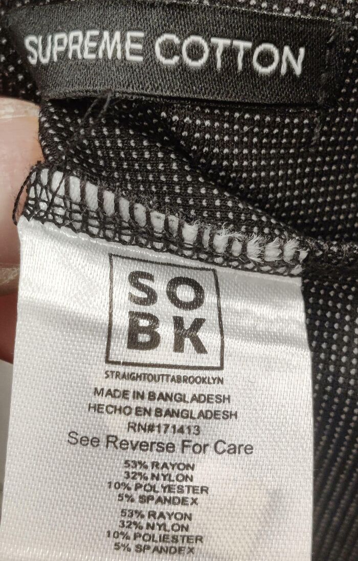 A clothing label marked Supreme Cotton made of rayon and polyester, showing terrible product design
