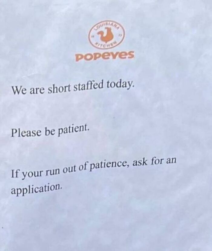 Popeyes staffing sign asking customers to be patient or request a job application